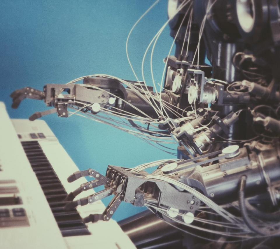 Thème : science des données et intelligence artificielle, photographie d'un robot jouant du piano.